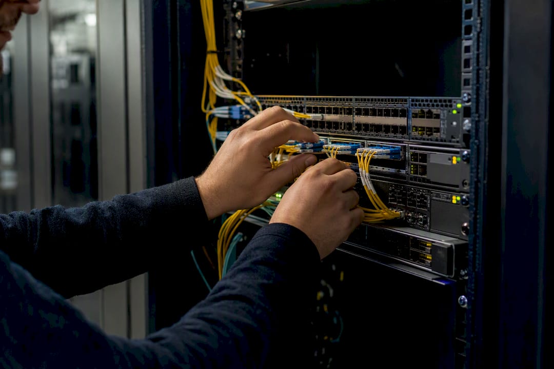 Hands configuring network hardware in data center