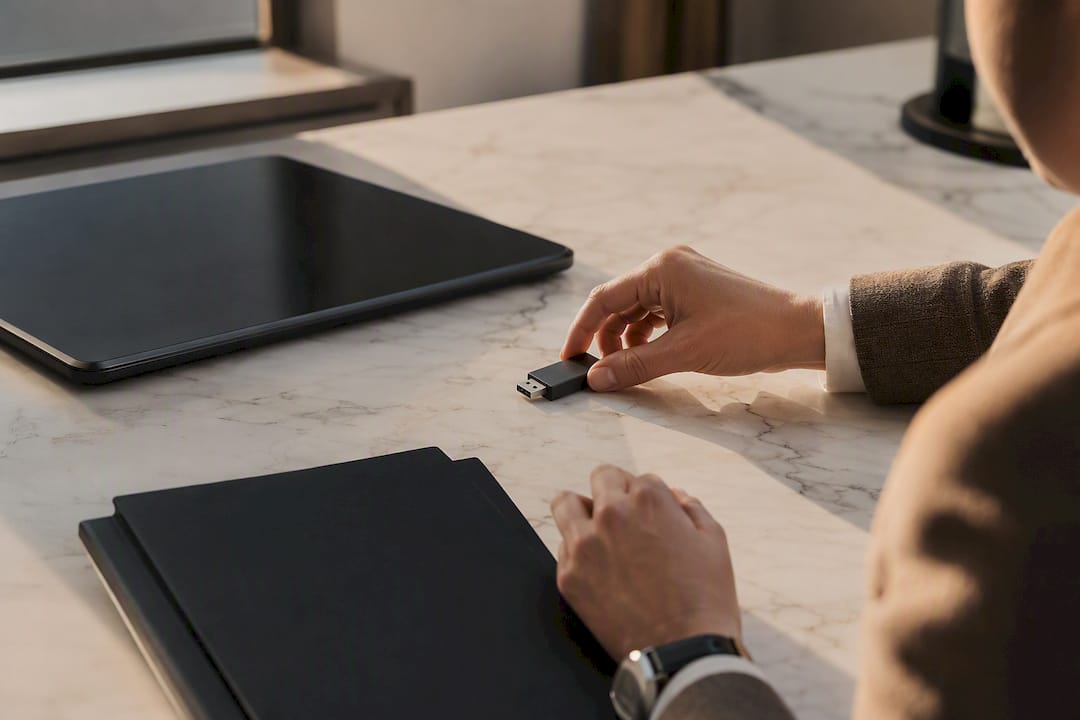 Hands placing hardware token on professional desk