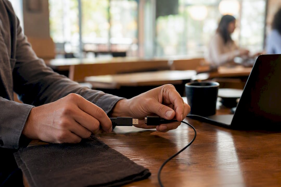 Hands connecting cables securing payment